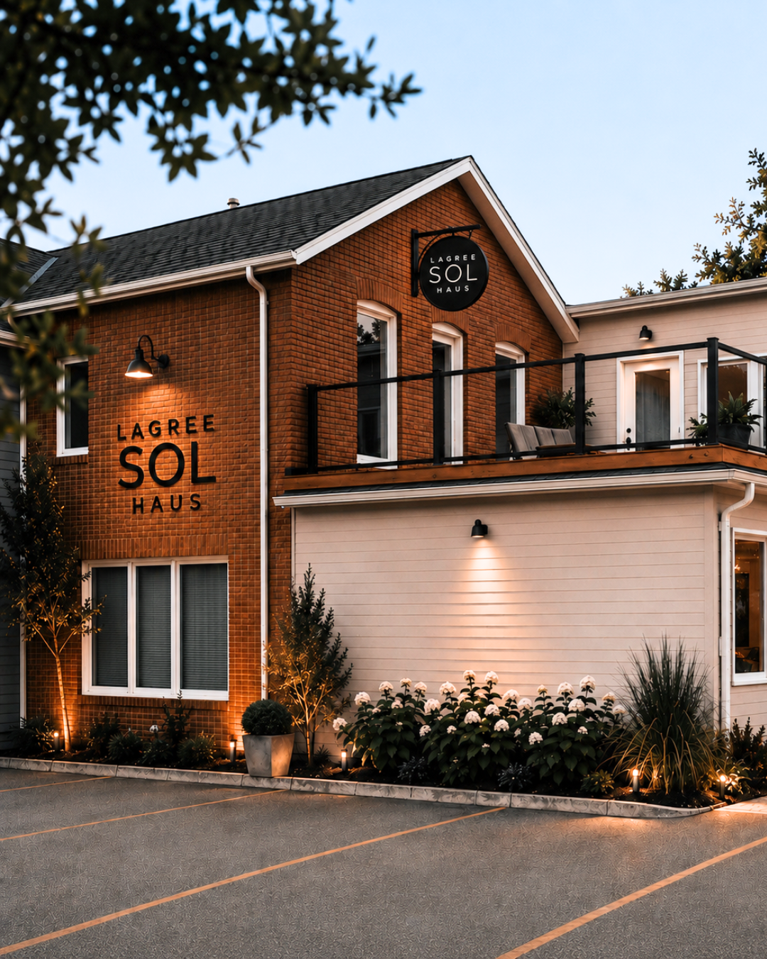 Lagree SOL Haus studio exterior lit at dusk with the SOL Haus sign