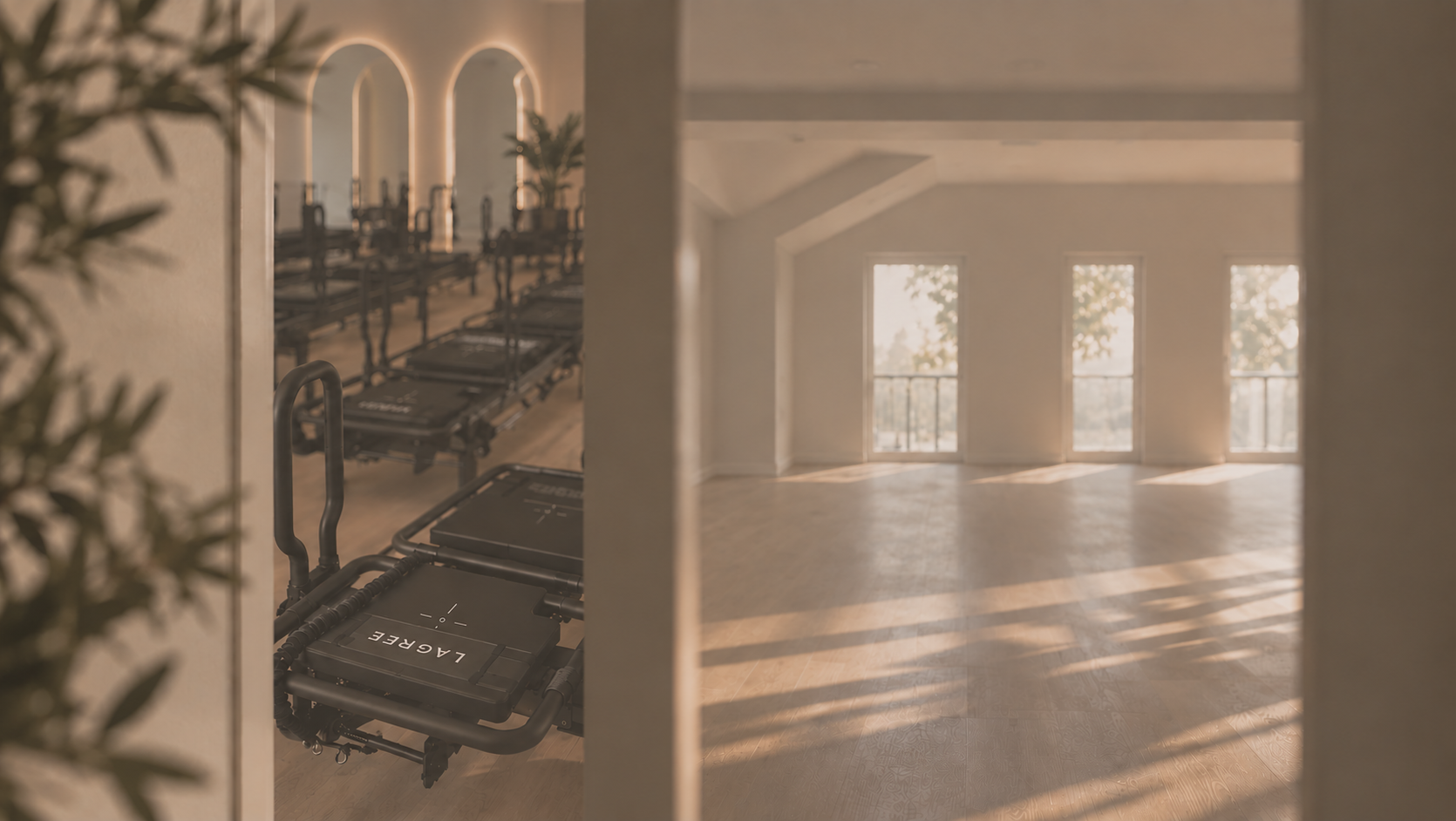 Sunlit studio interior with Lagree machines seen through an open doorway